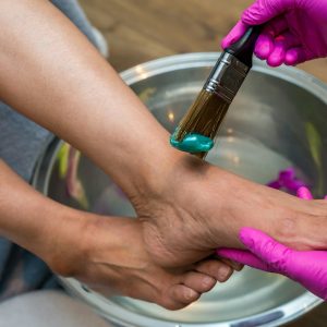person holding brush and foot